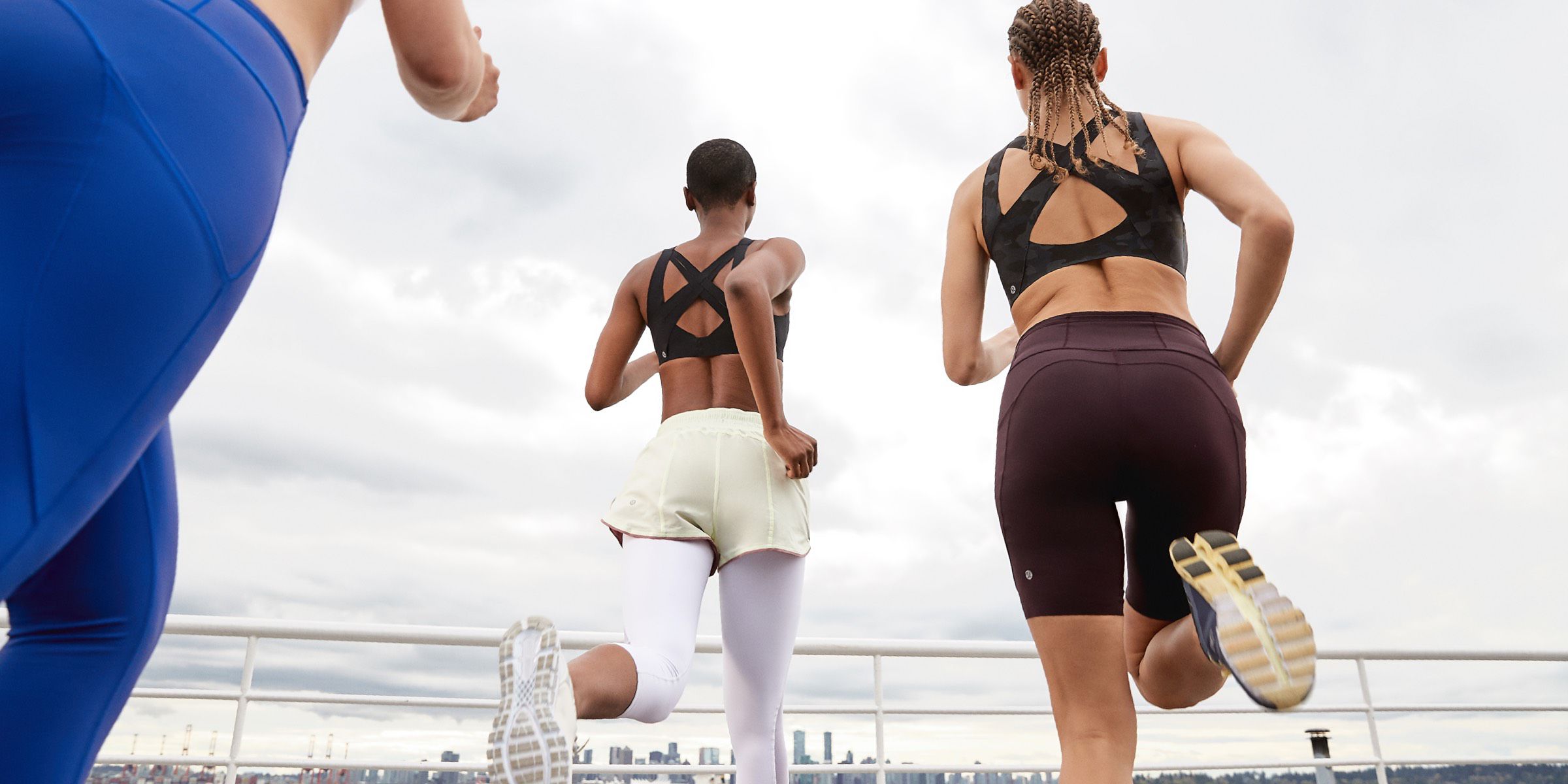 Two women do a workout together in lululemon bras. 