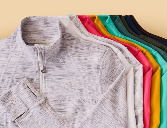 Different colour Define Jackets piled on top of each other. 