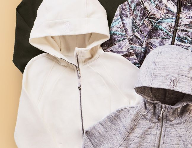 Different colored Scuba Hoodies laying on a beige surface. 