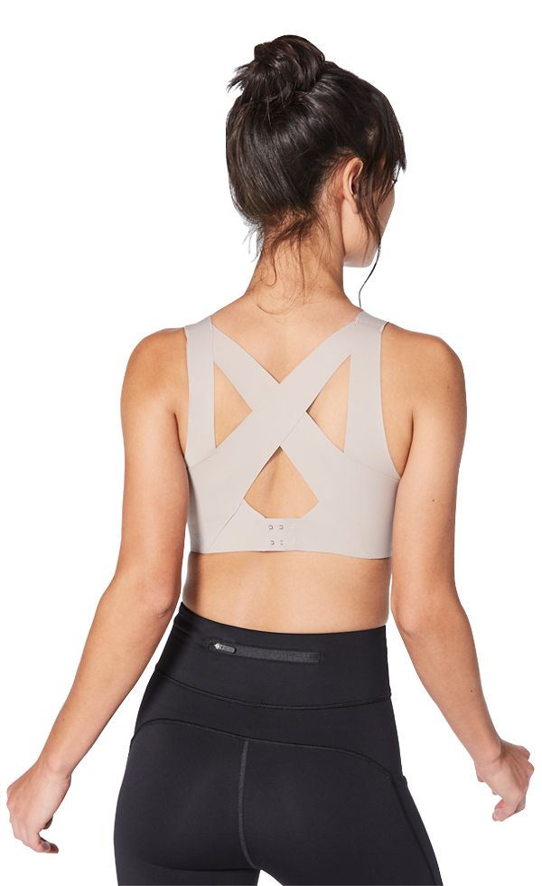 The back of a woman wearing an active beige bra. 