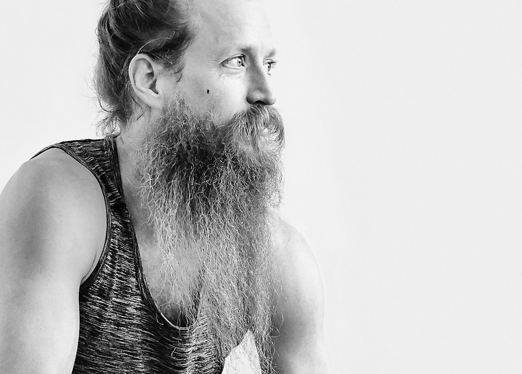 Ryan Leier leading two students through a yoga practice