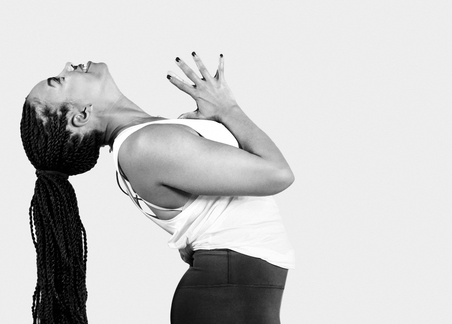 Chelsea Jackson Roberts leaning back with hands in prayer