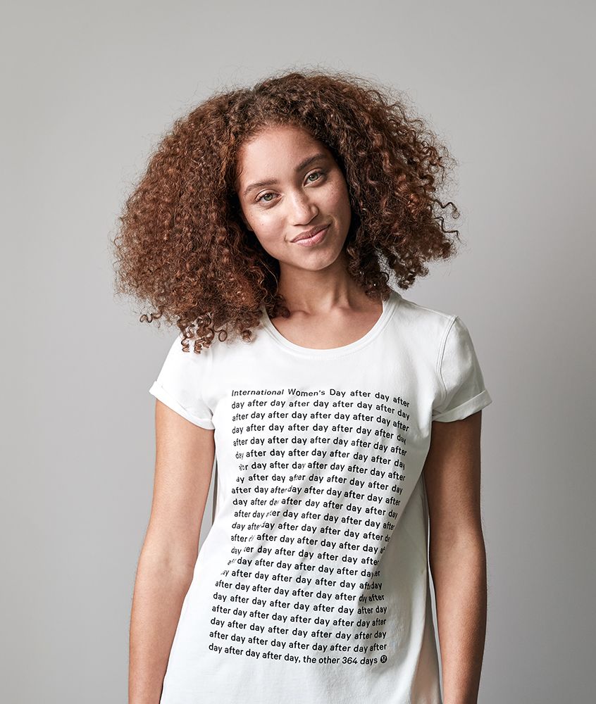 Image of a woman standing in the International Women’s Day t-shirt