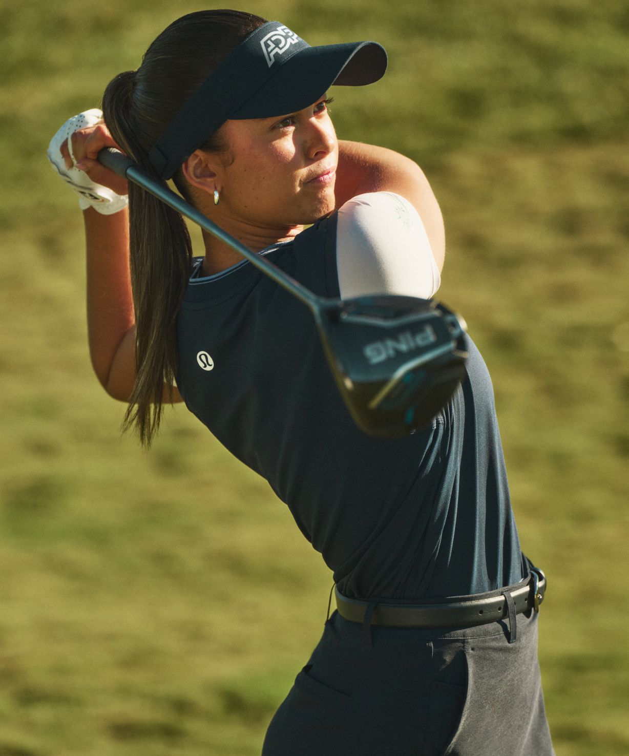 Close-up of a lululemon golf skirt being worn while putting.
