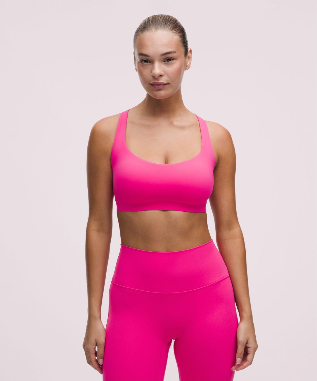 A person wears gear in Flamingo Tone from lululemon.
