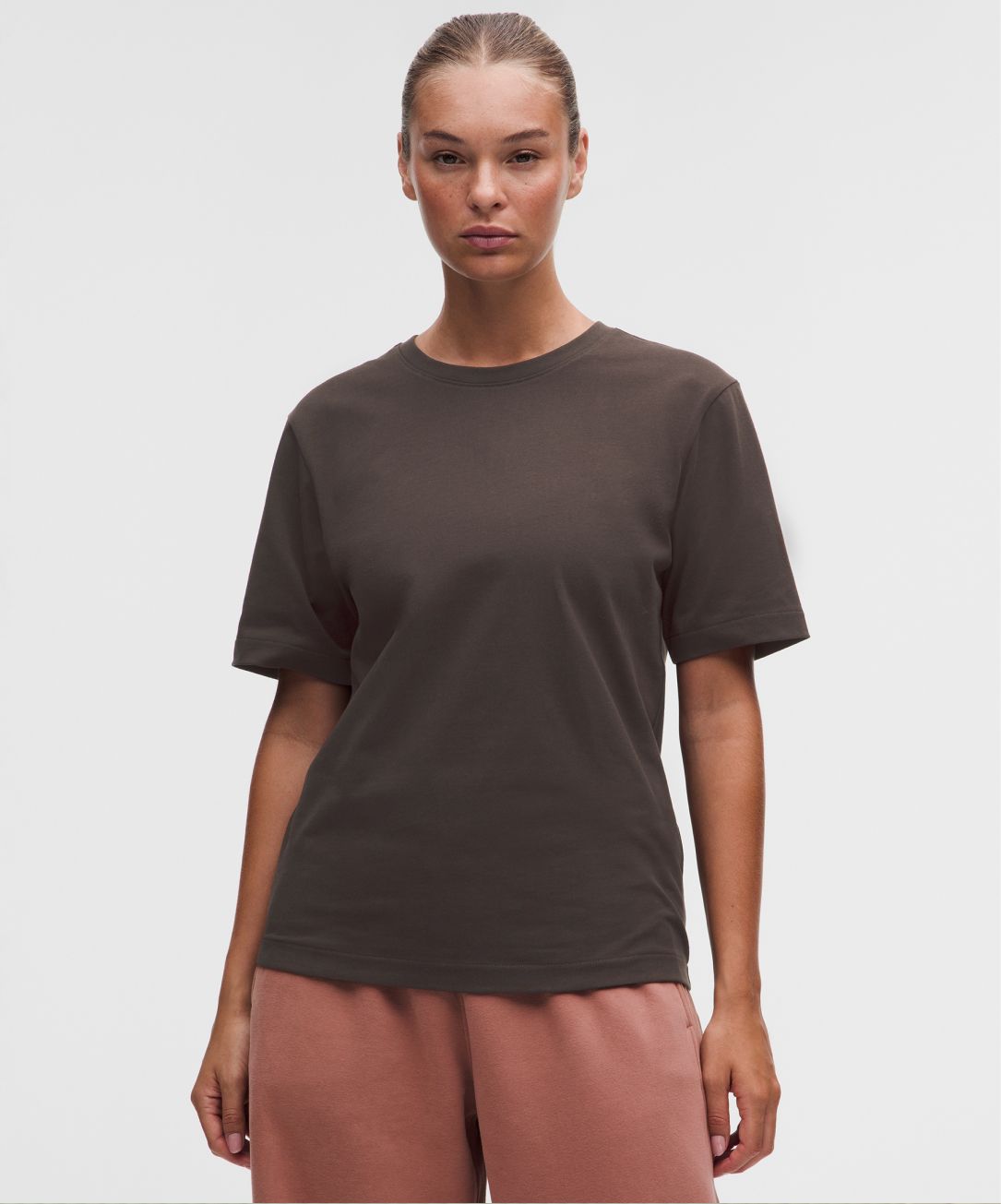 A person wears a loose-fit T-shirt from lululemon. 
