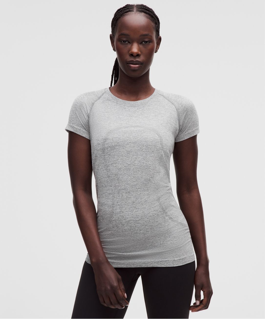 A person wears a slim-fit T-shirt from lululemon. 