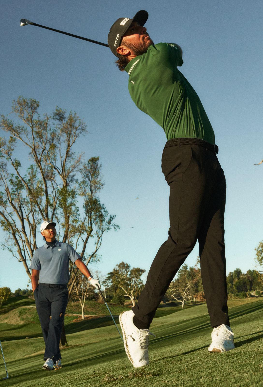 Max Homa takes a golf swing on a fairway while wearing lululemon.
