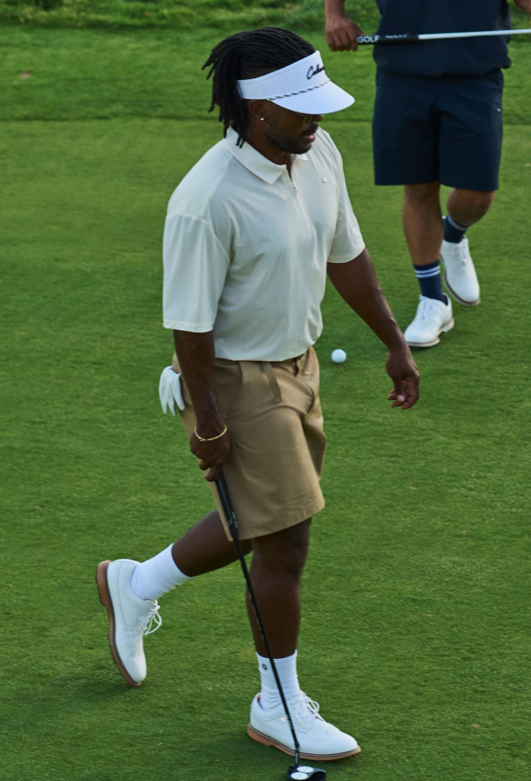 Ambassador Roger Steele walks towards a putt as his partner watches. They're both wearing new lululemon golf gear.