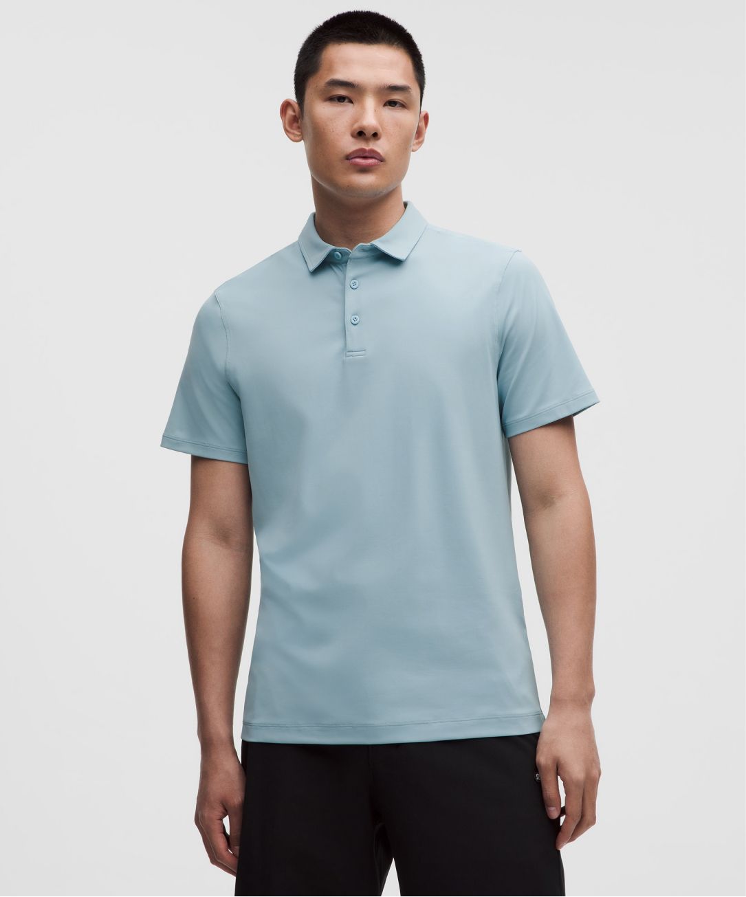 A person wears the Men's ShowZero Slim-Fit Polo Shirt from lululemon. 