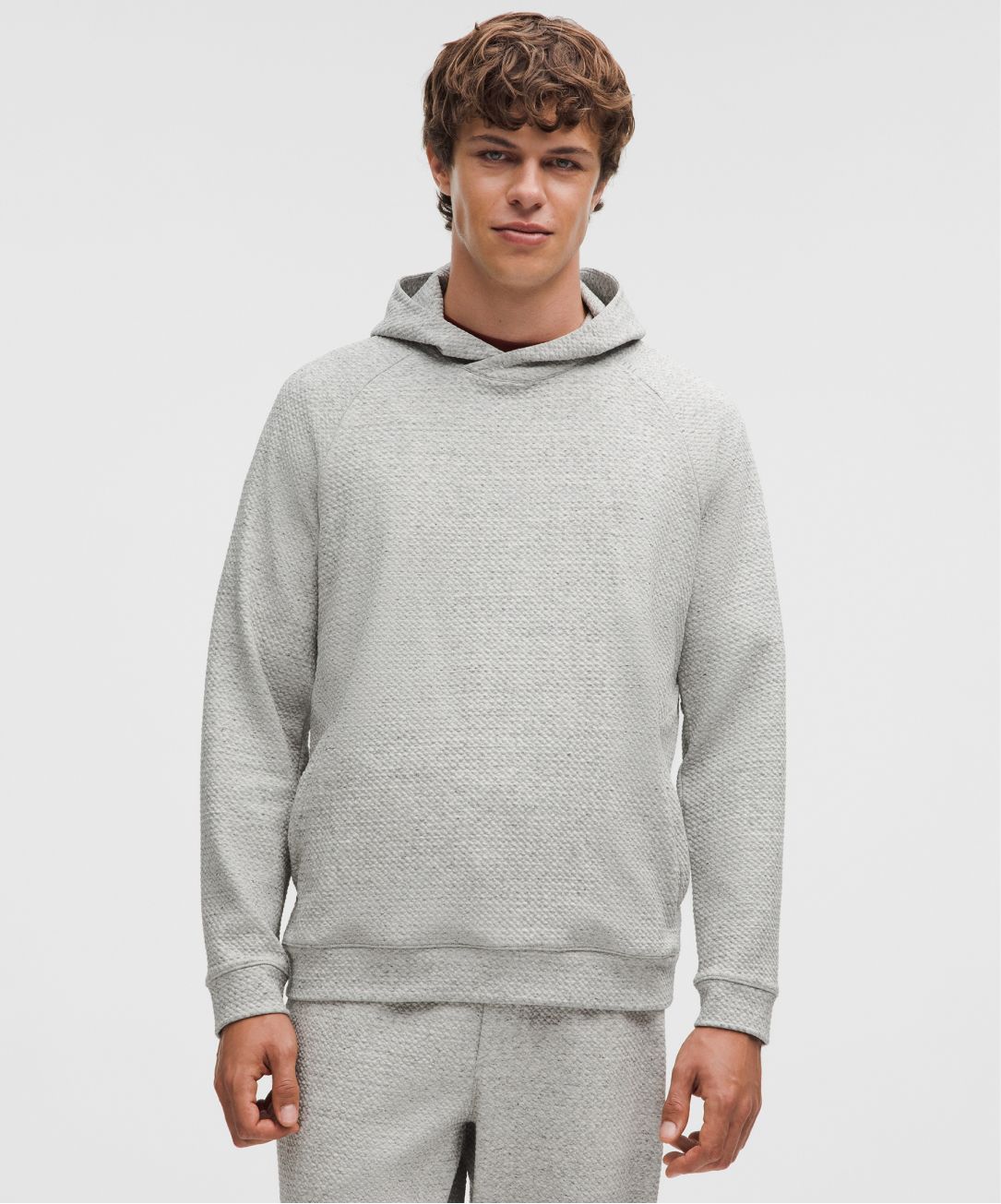 A person wears the Ease the Day Hoodie from lululemon.