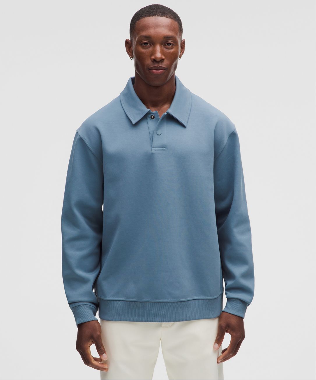 A person wears the Grand Standard Long-Sleeve Polo from lululemon.