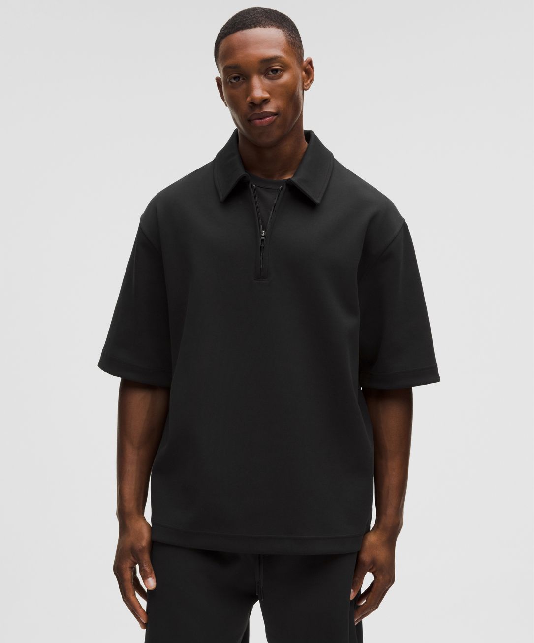 A person wears the Grand Standard Short-Sleeve Polo from lululemon.