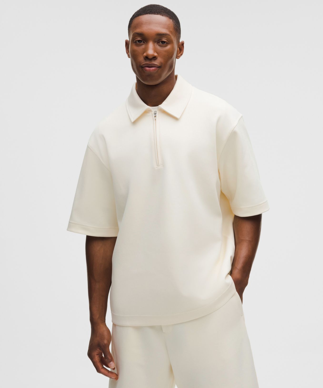 A person wears a Grand Standard Short-Sleeve Polo Shirt from lululemon.