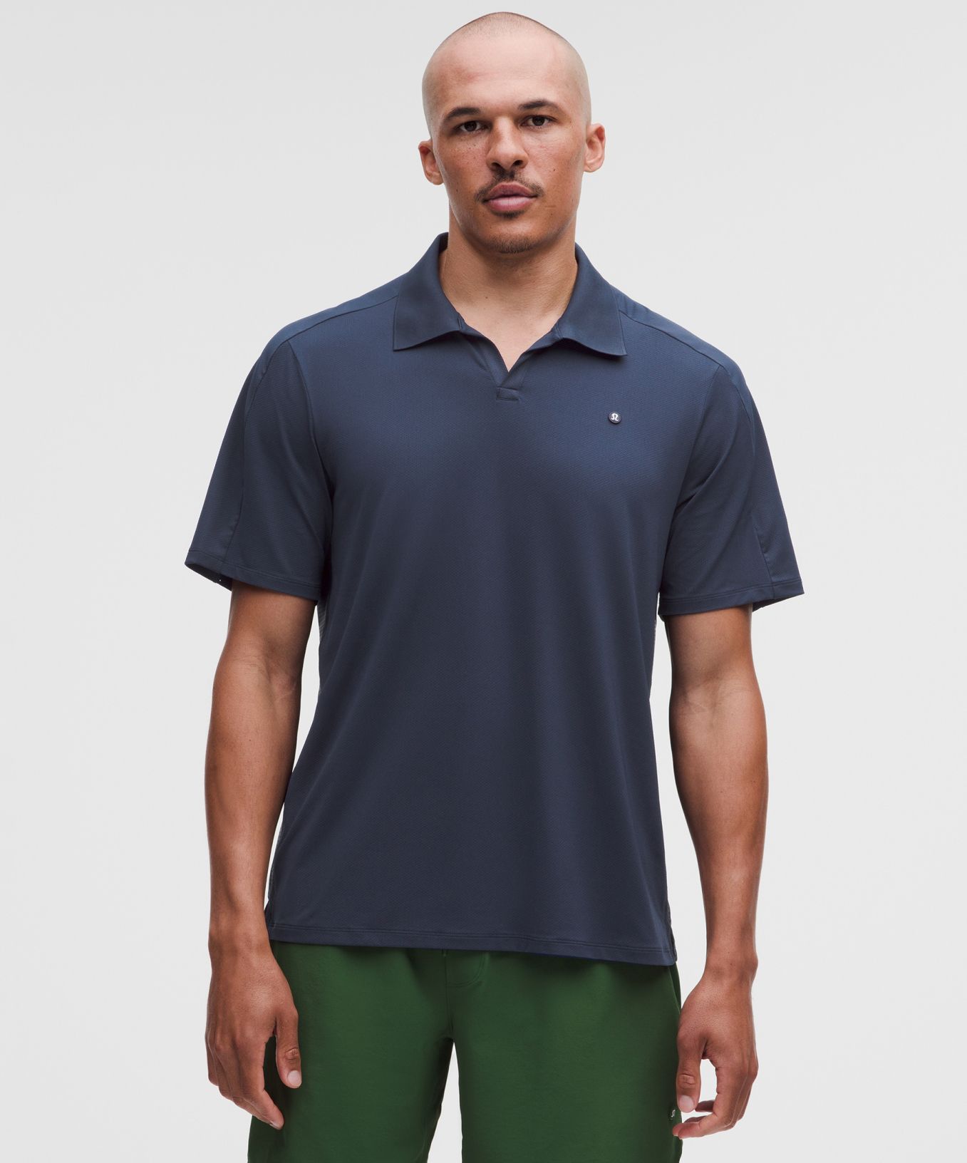 A person wears a Mesh Panelled Tennis Polo Shirt from lululemon. 