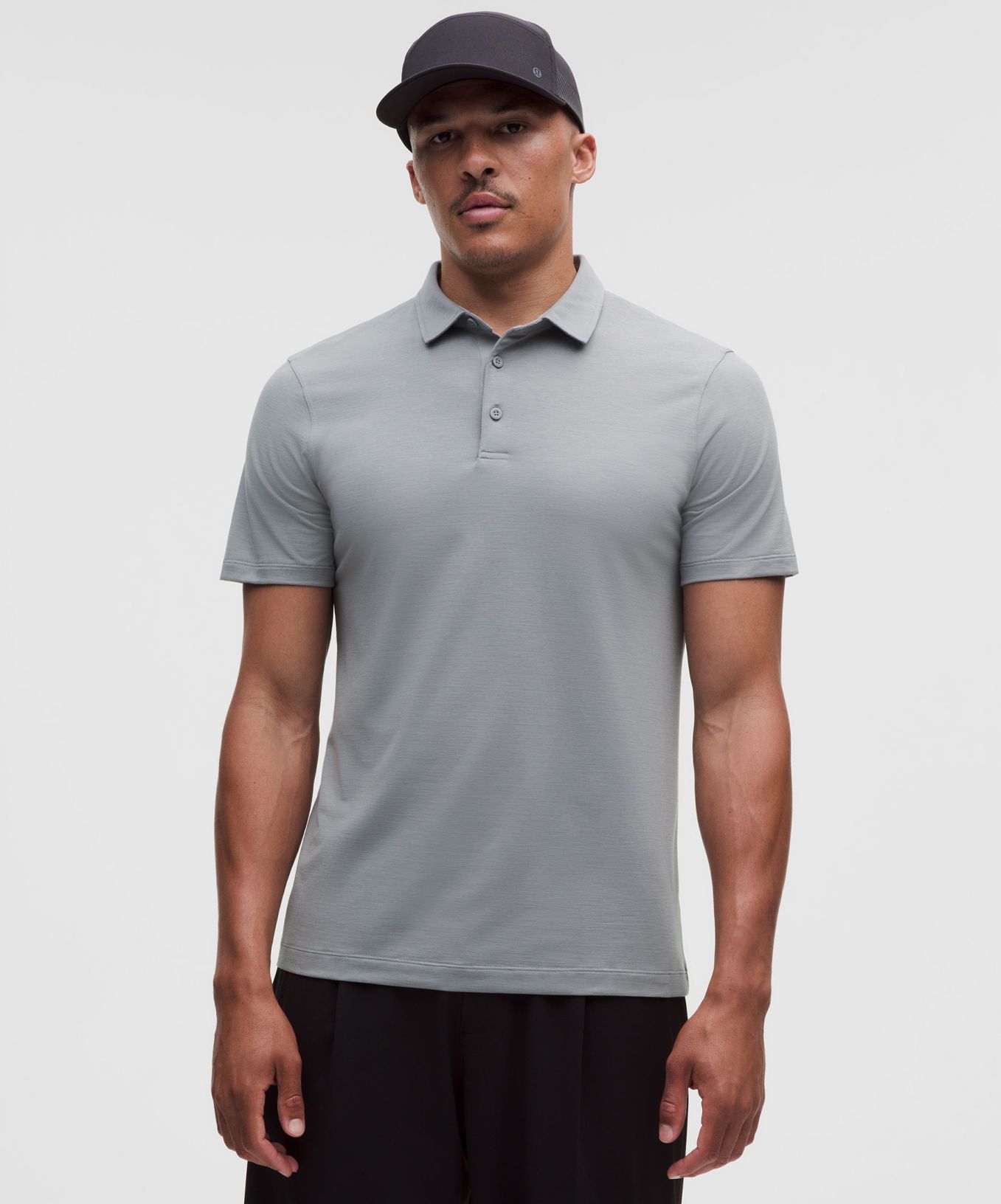 A person wears an Evolution Short-Sleeve Polo Shirt from lululemon.