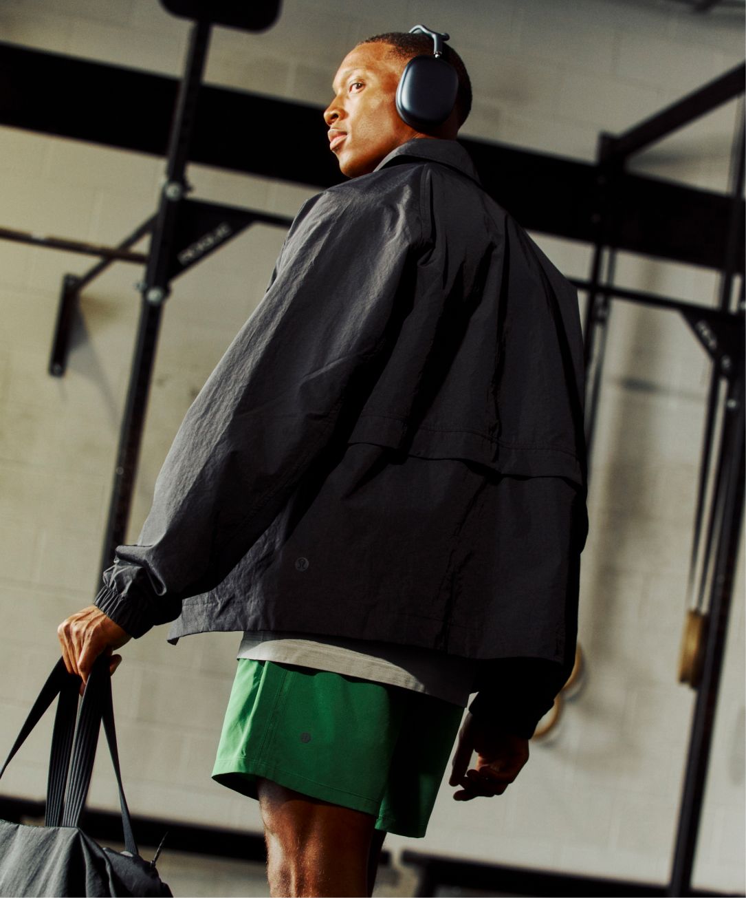 A person walks through a gym wearing the Cotton-Blend Collared Jacket.