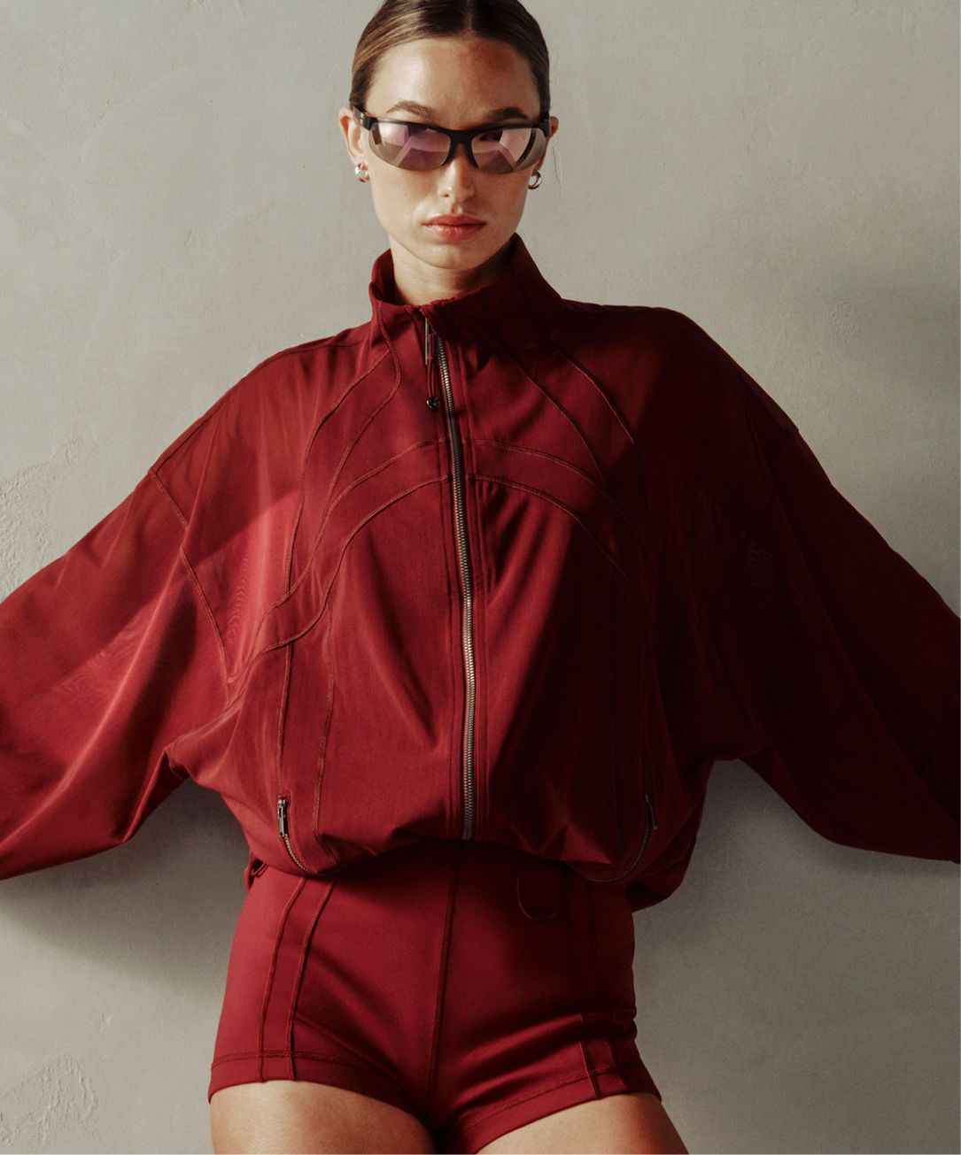 A person wears the Define Oversized Jacket and Define Micro Short. 