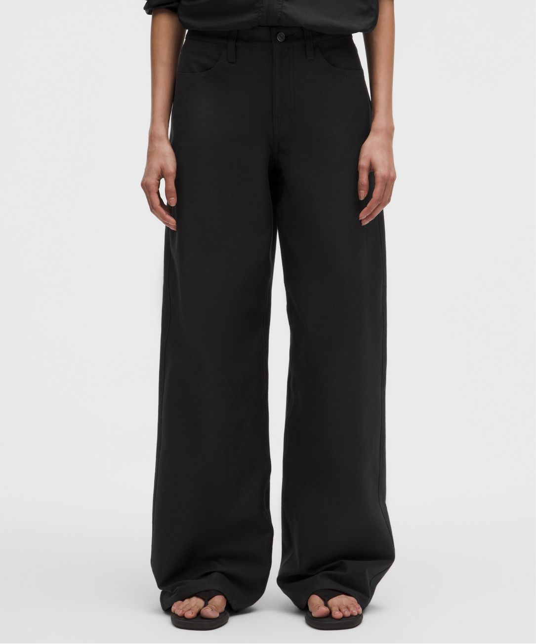 A person wears an EasyFive pant from lululemon.