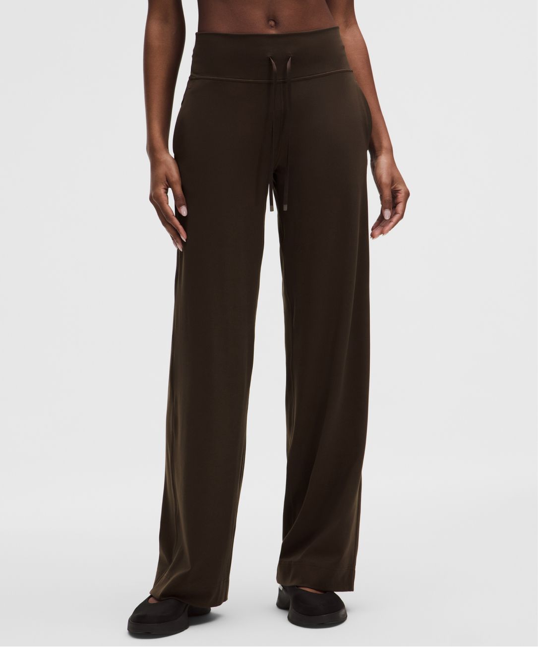 A person wears a Groove pant from lululemon.