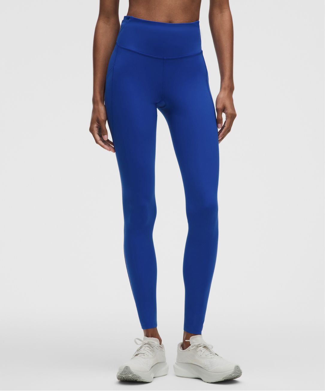 A person wears Fast and Free tights from lululemon.