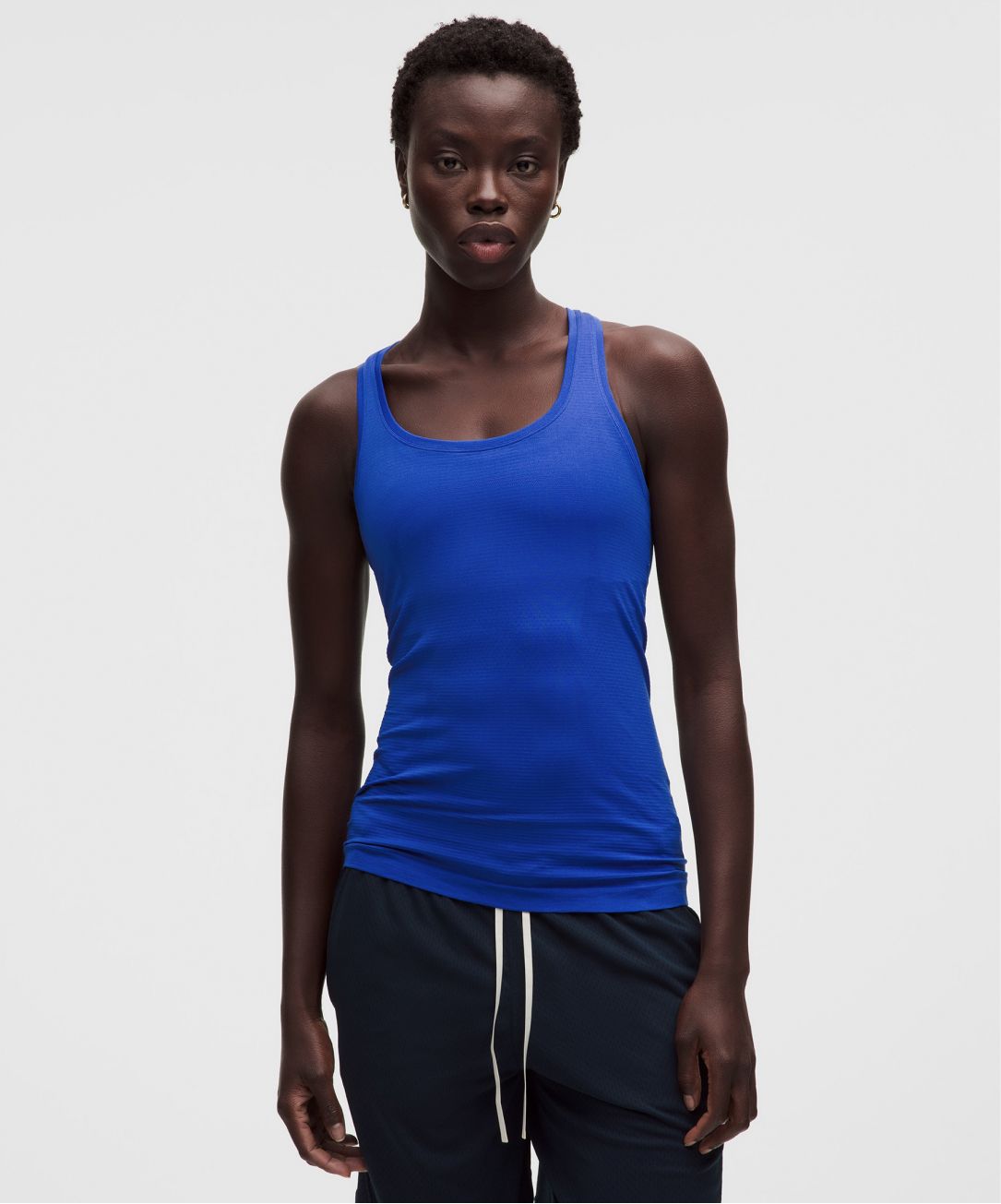 A person wears a Swiftly tank top from lululemon. 