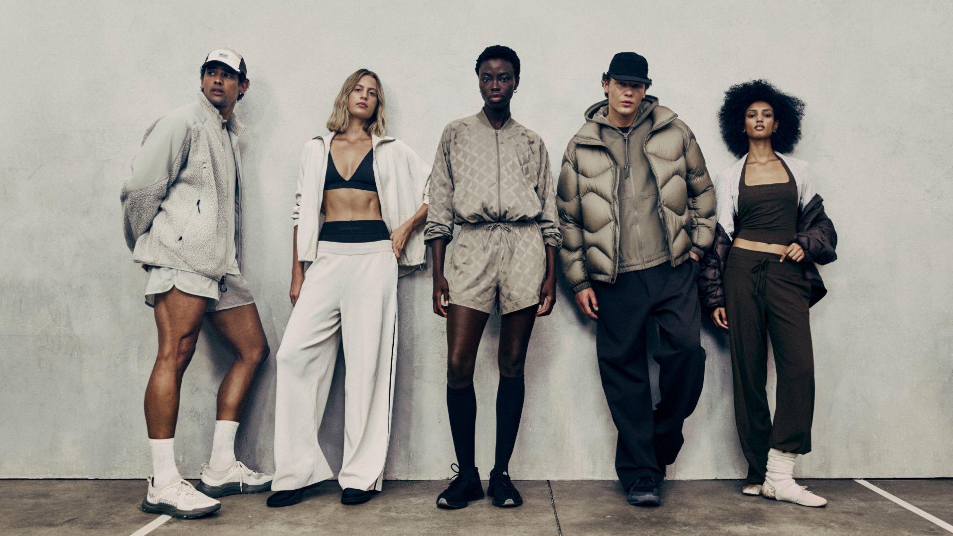 A group of people pose in a line. They are wearing new styles from the fall 2026 line. 