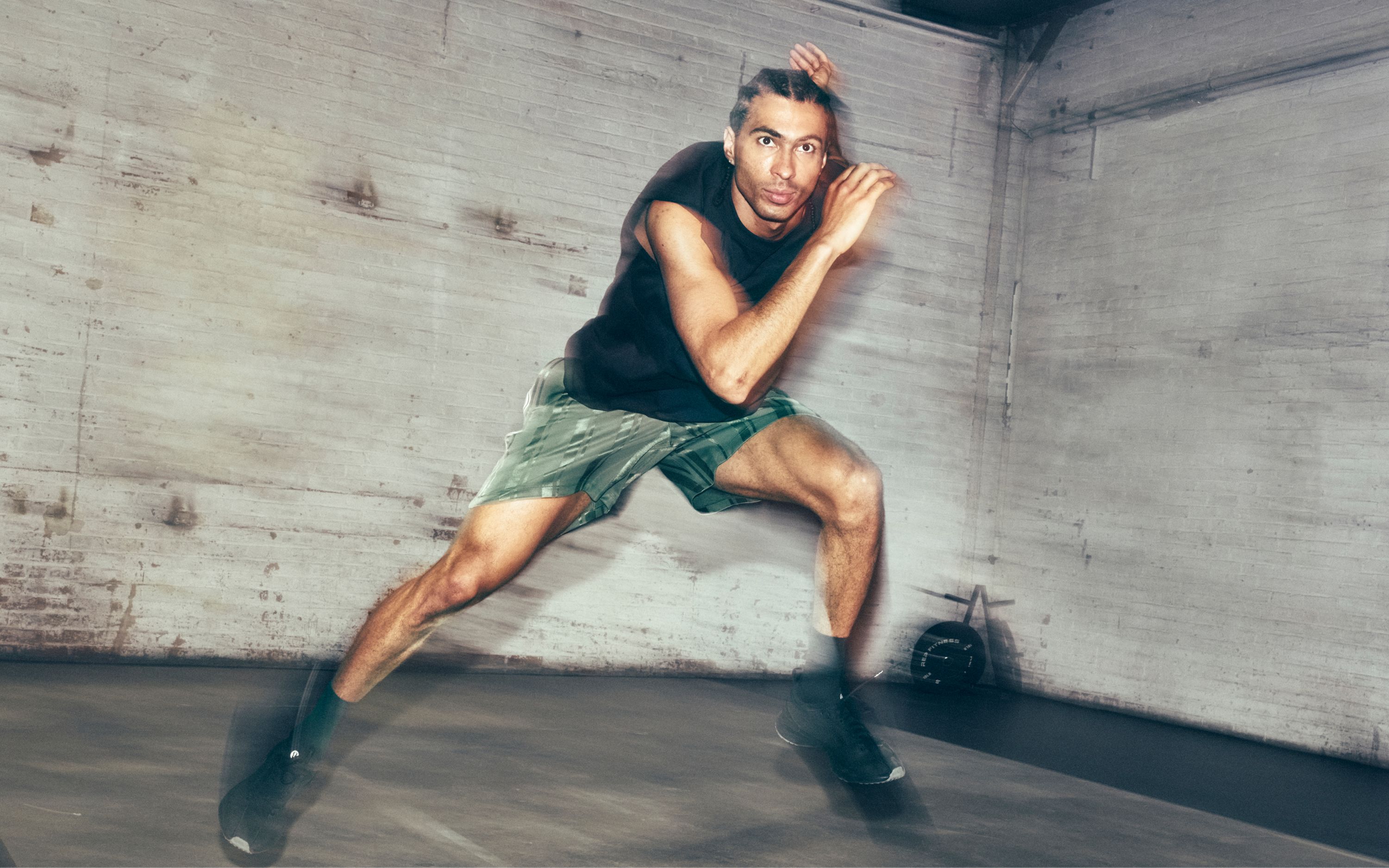 lululemon Ambassador William Dandjinou is mid-air completing a lateral lunge. He is wearing new styles from the fall 2026 line.