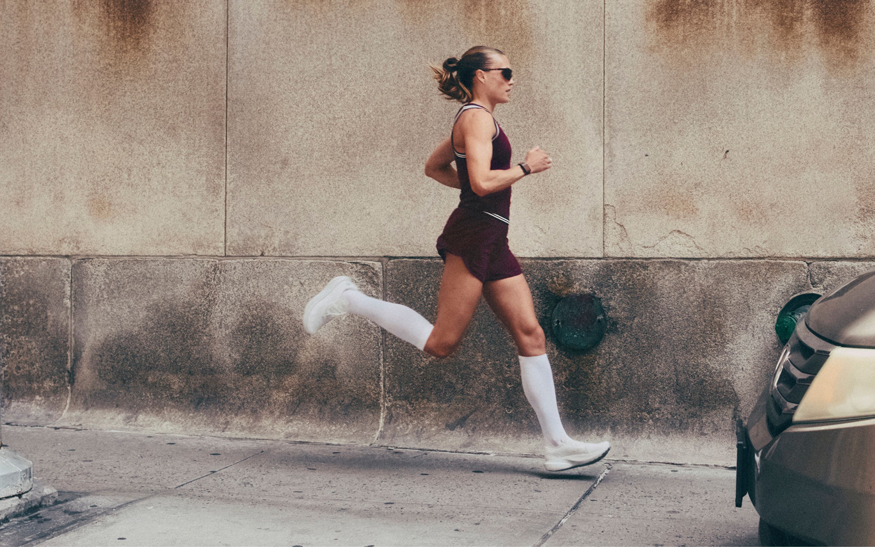 lululemon Ambassador Colleen Quigley runs down the street wearing new styles from the fall 2026 line.   
